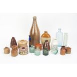 A collection of stoneware bottles, jars, inkwells. potted meat jars, glass bottles and phials