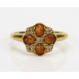 A 9ct Gold, Diamond and Orange Stone Cluster Ring, hallmarked, 10.5mm head, size M, 3.11g