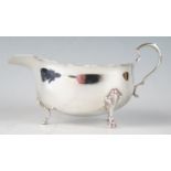 A George V silver sauce boat, maker Adie Brothers, Birmingham, 1932, with wavy edge border, scroll