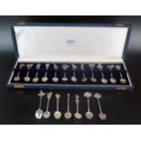 A collection of South American and Asian silver spoons, with decorative terminals of birds, animals,