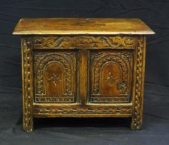 An antique oak small coffer, with rectangular top, the twin panelled front with lunette carved