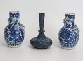 A pair of Chinese blue and white miniature vases, with applied dragon decoration, 9cm high, together