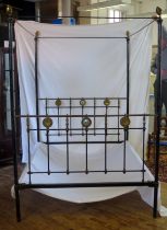 A Late Victorian tubular metal four-poster double bed, with bed ends, side rails and drapery