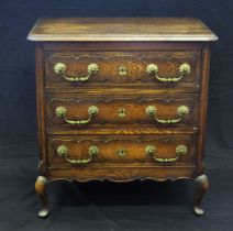 A continental oak chest of rectangular outline, the top with a moulded edge, containing three