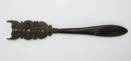 A Massim lime spatula, Trobriand Islands, Papua New Guinea, the handle surmounted with stylised