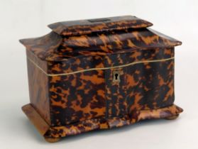 A 19th century blonde tortoiseshell tea caddy, of serpentine outline, the domed hinged lid enclosing