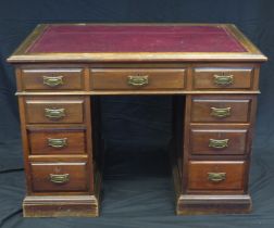 An Edwardian mahogany twin pedestal writing desk, the top with tooled leather writing surface,