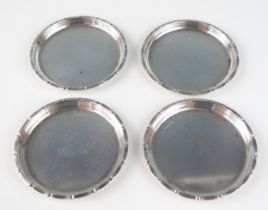 A set of four Swedish silver circular coasters, stamped marks for 1945, with crimped border, 8cm