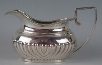 A Victorian silver barge-shaped cream jug, maker's mark worn, Birmingham, 1895, with gadrooned