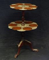 A Mahogany two tier dumb waiter in the Georgian style, the circular top with carved flowerhead and