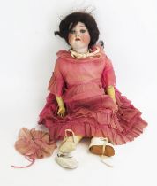 A German Bisque Headed Doll inscribed 136/8 with blue glass opening eyes with 4 teeth, brown wig,