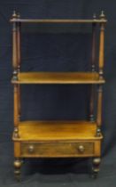 A Victorian mahogany three tier what not, with turned columns with single drawer to the base, on