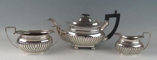 A matched three-piece silver tea service, of barge-shaped outline, the teapot maker GAG,
