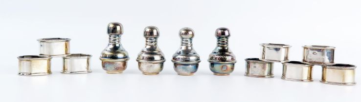 A set of eight Middle Eastern silver napkin rings, together with two pairs of condiments, total