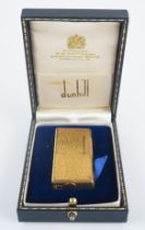 A gold plated Dunhill 70 lighter, with bark design, cased.