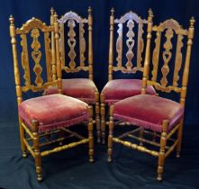 A set of four 19th century fruitwood and inlaid dining chairs with pierced splats and stuff over