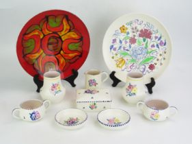 A collection of assorted Poole pottery wares, includes plates butter dish, cups, jug and finger