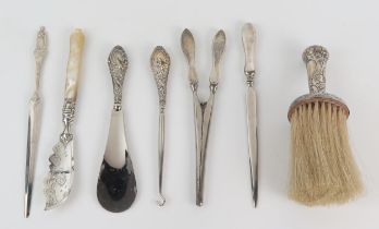 A silver handled brush, silver handled shoe horn, glove stretchers, butter knife, letter openers and