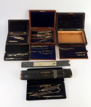 A collection of cased drawing instruments, slide rule, boxes etc.