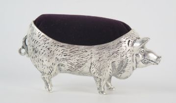 A continental silver novelty pin cushion, stamped 800, in the form of a pig, 11cm long.