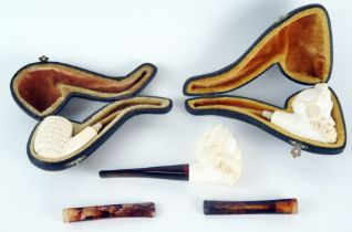 A carved meerschaum pipe in the form of a Turks head, lacks mouthpiece, cased, another similar