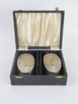 A pair of Elizabeth II silver backed brushes, maker W I Broadway & Co, Birmingham, 1964, with engine