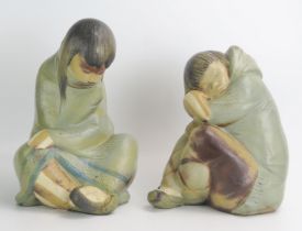 A pair of Lladro figures of seated Eskimo children, each 30cm and 28cm high. (2)