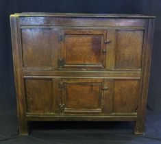 An 18th century oak dresser, with ledged top, with panelled cupboard door having pierced floral