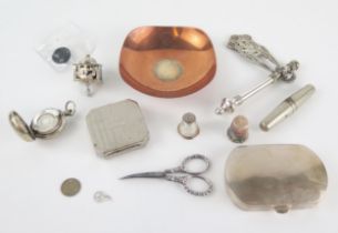 A Jewish silver rattle (groger) with pierced decoration, a sterling silver gambling dreidel, a