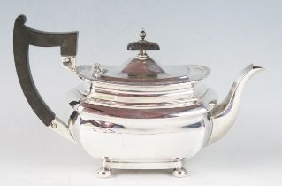 An Edward VII silver barge-shaped bachelors teapot, make Walker & Hall, Sheffield, 1909, with