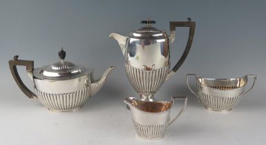A matched four-piece tea and coffee service, various makers and dates, of oval form with half reeded