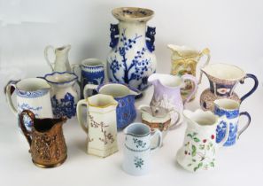 A collection of late Victorian and later pottery jugs, including moulded jugs, transfer print