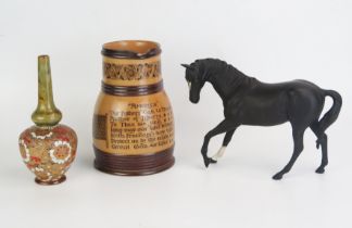 A Royal Doulton model of a black stallion, a Doulton Lambeth ware cordial jug "America" and a