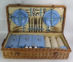 A Coracle wicker picnic hamper possibly for Harrods (label missing), with plates, flatwares, thermos
