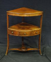 A Georgian mahogany corner washstand, with single frieze drawer, on swept legs united by an under-