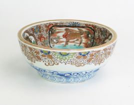 A 19th century Japanese famille verte bowl, the interior decorated with cartouches of landscapes and