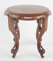 A Chinese polished hardwood stand of circular outline raised on four swept and pierced legs, 17cm