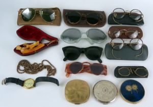 A collection of assorted sun glasses, spectacles, powder compacts, wrist watch etc.