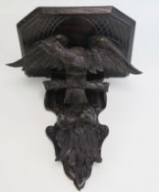 A carved hardwood wall bracket, the shelf supported by an eagle with outspread wings, overall height