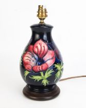 A Moorcroft pottery table amp of ovoid form with piped Anemone pattern decoration, mounted on a