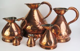 A matched set of six 19th century copper graduated measures, of traditional design,