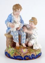 A Paul Duboy porcelain spill vase decorated with a seated boy and kneeling girl playing with