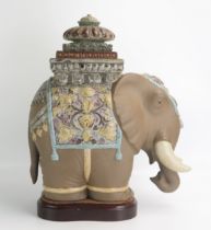 A Lladro porcelain model of a Siamese elephant, on polished wood base, overall height 43cm high.