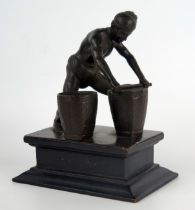 A Burmese bronze study of a peasant levelling seed in a basket, unsigned mounted on a rectangular