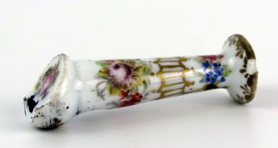 A Meissen porcelain whistle with floral decoration heightened in gilt, bears underglaze blue crossed