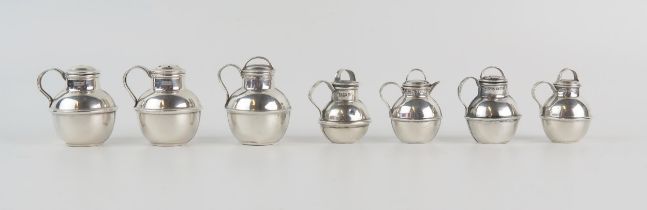 Four assorted silver Guernsey style miniature jug condiments, various makers and dates, and three