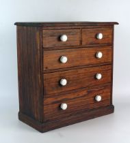 A miniature pitch pine chest of two short and three long graduated drawers on a plinth base, 33cm