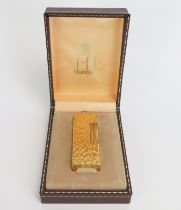 A gold plated Dunhill 70 lighter, with bark design, cased.