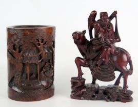A Chinese carved bamboo brush pot, decorated with figures in a pagoda landscape, 18cm high, and a