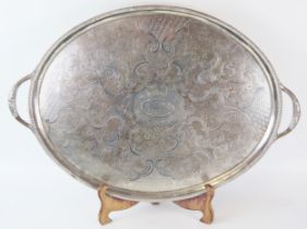 A large Sheffield plate serving tray, of oval outline, the central cartouche bearing a crest,